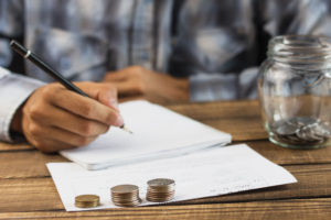 Man With Saving Jar Counting - Contabilidade em Santa Catarina | Amaral Contabilidade